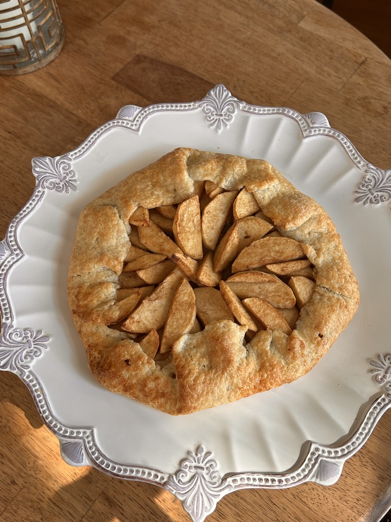 Close-up of a baked apple galette showing golden, flaky crust and apple filling.