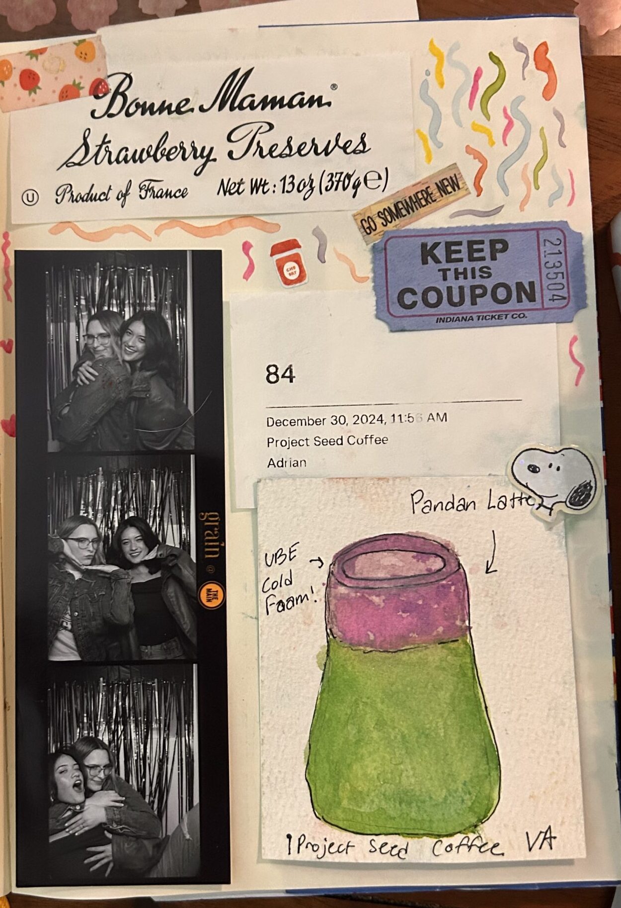 A cozy table scene filled with pens, watercolor swatches, handwritten notes, labels, and open journals.